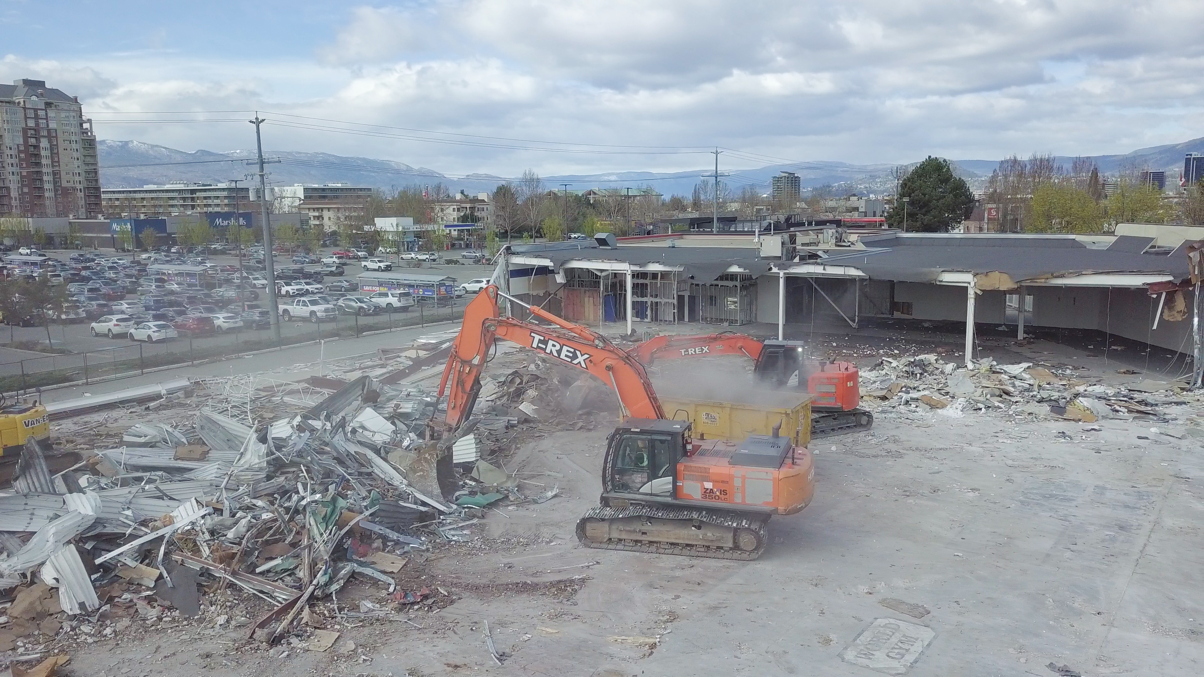 Excavator clearing debris
